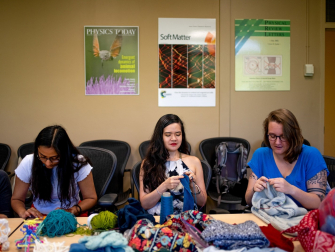 Elisabetta Matsumoto (center) knits with two of her Matsumoto Group lab students at Georgia Tech. (Photo Jonathan Kelso, The New York Times.)